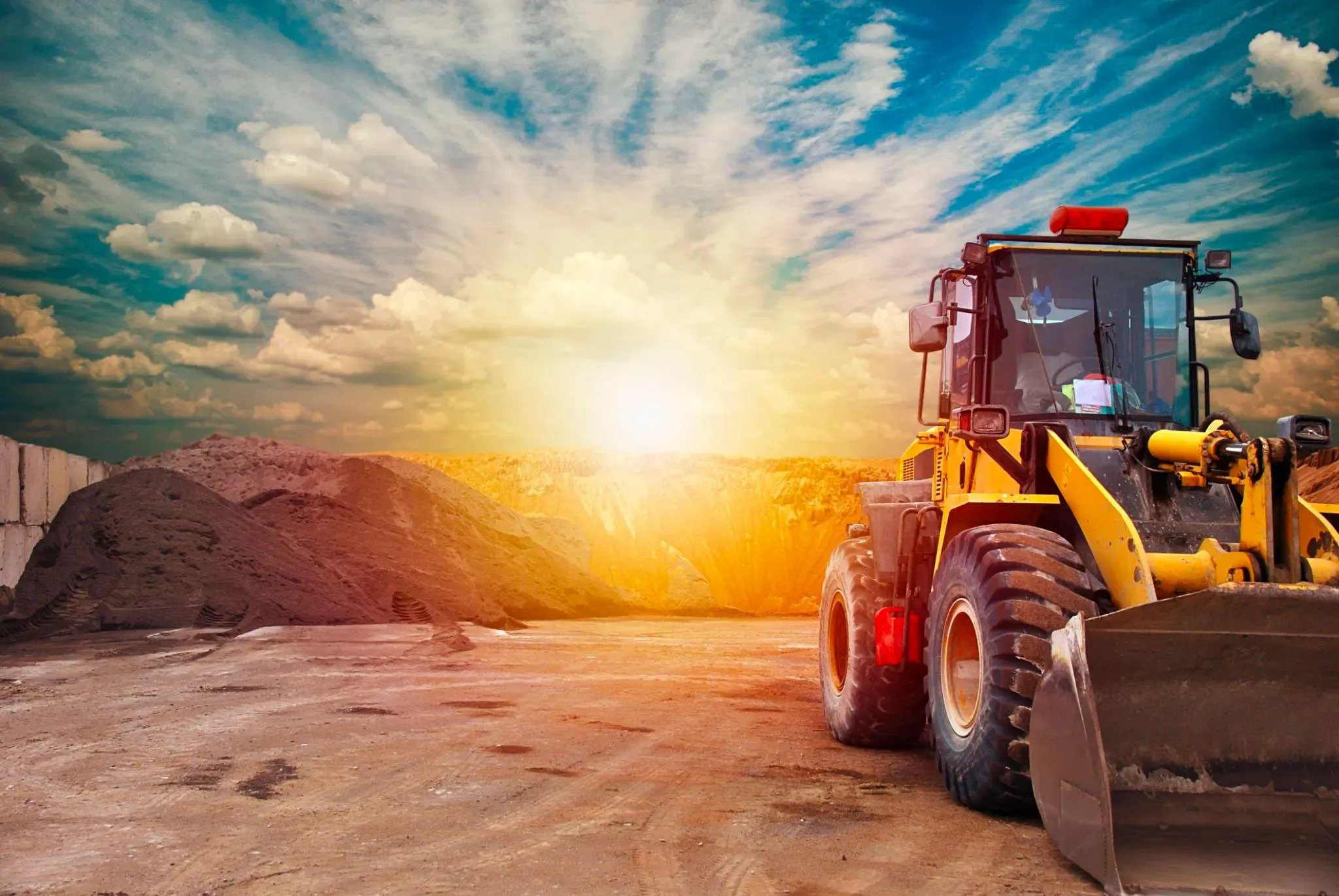 Cargador de Constructora GyN trabajando en un movimiento de tierras al atardecer